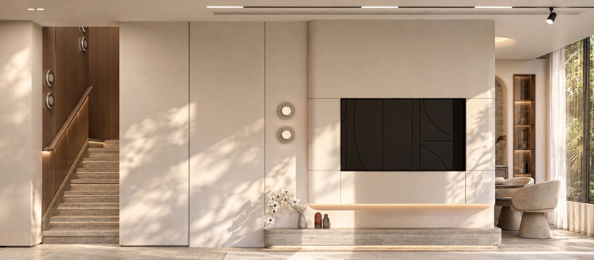 Entrance hall of the Mudon villa with a timber-clad staircase and a television wall on a travertine plinth