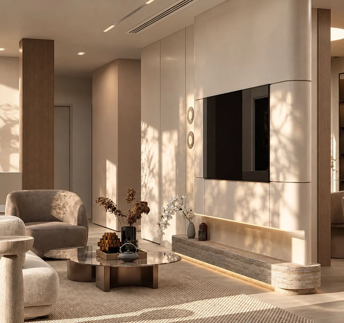 View across the living room of the Mudon villa towards the hall, with an olive tree and a bronze sculpture beyond the columns