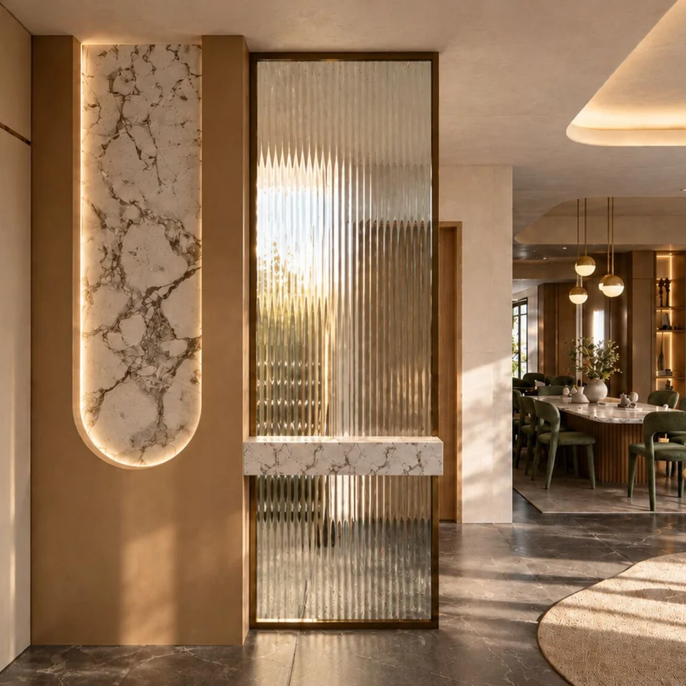 Fluted glass screen in a bronze frame beside a lit stone niche at the entrance of a Sharjah Sustainable City townhouse